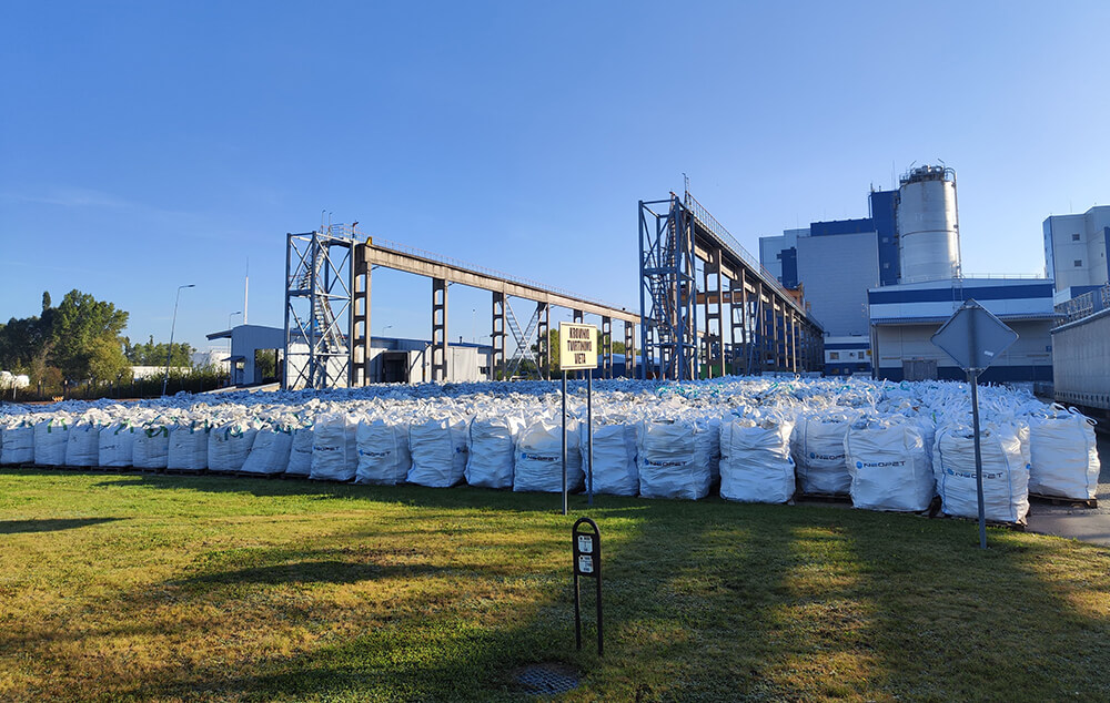 Stacked PET resin bags outside Neo Group’s manufacturing site in Lithuania